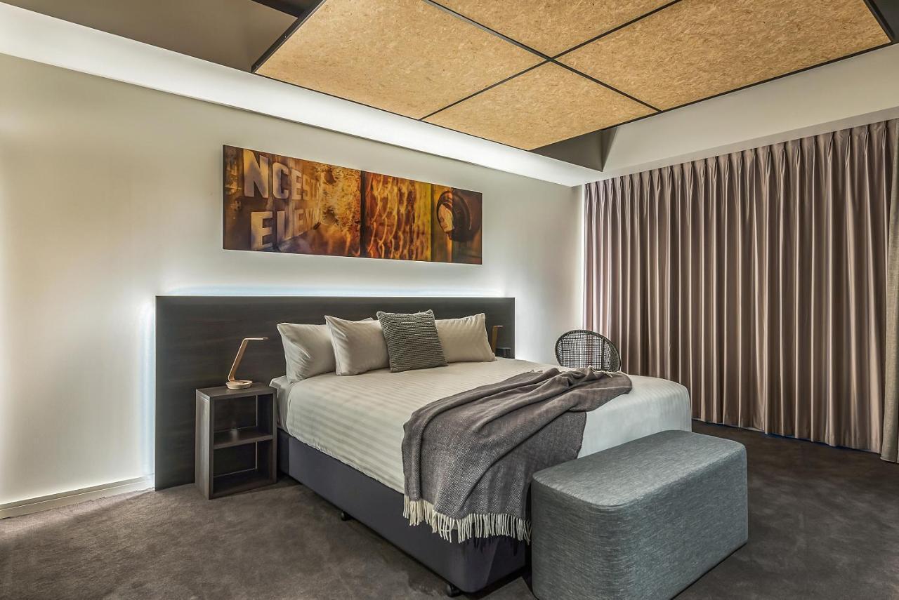 Hotel Peppers Silo Launceston Pokoj fotografie A bedroom with a bed and a stool